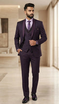 Man wearing a purple suit in a modern room
