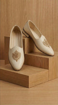 Cream Leather Mojdi Shoes with Gold Crest Embroidery | Dresswala NX