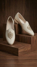 Ivory Crest Textured Mojdi Shoes with Gold Crest Embroidery | Dresswala NX